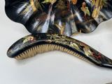 a hair brush and a comb sitting on a table