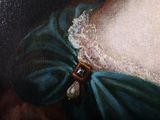 a painting of a woman wearing a green dress and a pearl broocher