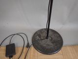 a lamp that is sitting on the floor next to a charger