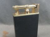 a black and gold lighter sitting on top of a table