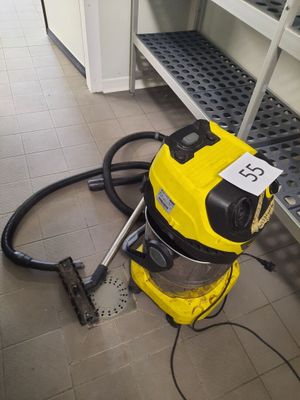 a yellow vacuum that is on the floor in a room
