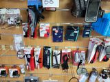many different cell phones on the wall in this store