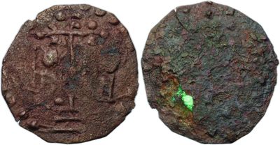 a close up of a coin with a green leaf on it