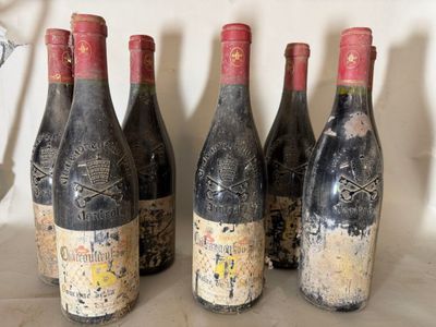 four bottles of wine are lined up on a table