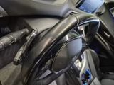 a steering wheel in a car with a charger plugged into it