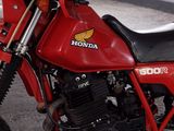 a red motorcycle that is parked in a garage