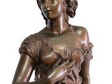 bronze statue of a woman holding a bird on a white background