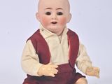 a small doll that is sitting on the ground