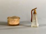 a small glass bottle and a small glass bottle on a table
