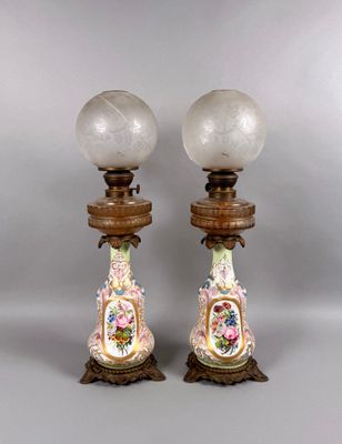 pair of antique porcelain lamps on wooden bases with glass globes