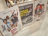 three movie posters on display in a store