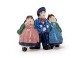 three figurines of people standing together on a white surface