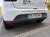 a white car parked in a parking lot with a sticker on the back