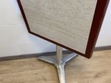 a small table with a wooden top on a wooden floor