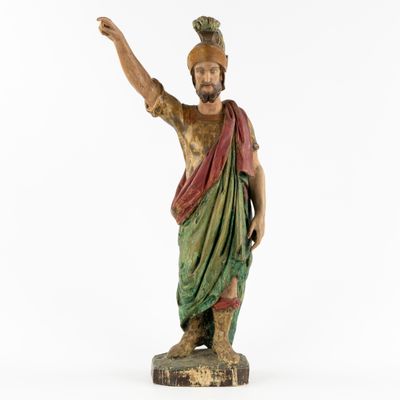 an old statue of a man with a hat on his head