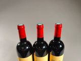 three bottles of wine that are sitting on a table