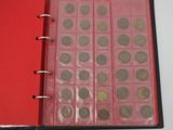 a red binder with a lot of coins inside of it