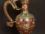 a gold and red vase with a dragon on it