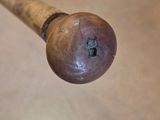 a baseball bat that has a wooden handle on it