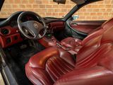 a picture of a car with red leather seats and a steering wheel