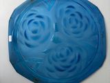 a blue glass plate with a circular design on it