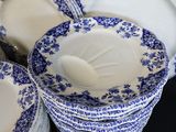 a lot of blue and white plates stacked on top of each other