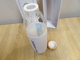 a bottle of water sitting on a table next to a bottle of water