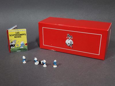 une boîte rouge sur laquelle sont posées de petites figurines et un livre