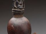 a close up of a vase with a rope around it