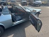 a car that is parked in a parking lot with its door open