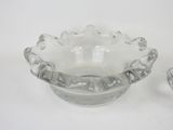 a small glass bowl with a silver lid and a small glass bowl with a silver lid on a white surface