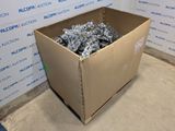 a cardboard box full of scraps sitting on the floor