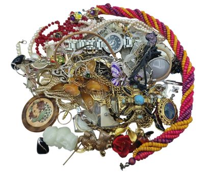 a pile of assorted jewelry on a white surface