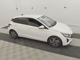 a white car parked in a garage with a checkered floor