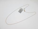 a close up of a silver necklace with a tag on it