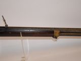 an old rifle with a wooden handle and a metal handle