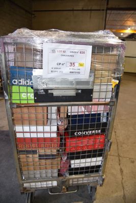 a metal cart with many boxes on it in a warehouse