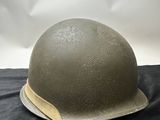 an army helmet on a black cloth with a white background