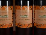 three bottles of wine sitting on top of a table next to each other