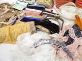 many different types of clothing and accessories on a table
