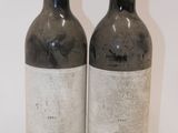 two bottles of wine sitting next to each other on a table