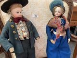 two dolls that are standing next to each other