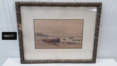 painting of boats on the water in a frame on a table