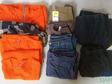 several pairs of men ' s clothing are laid out on a table