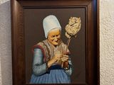 a painting of a woman holding a broom and a flower
