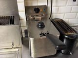 a toaster and a toaster sitting on a counter in a kitchen