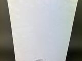 a white book with a black cord on top of it