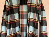 a close up of a shirt hanging on a hanger on a wall