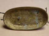 a metal tray with a handle on it on a table