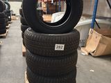 tires stacked on pallets in a warehouse with boxes and pallets